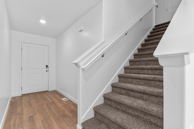 1907 East 640th North, Unit 1225 Salem, UT 84653 - Photo 15 of 20 Entry foyer featuring wood-finish flooring, a white paneled door with smart lock hardware, and recessed lighting
