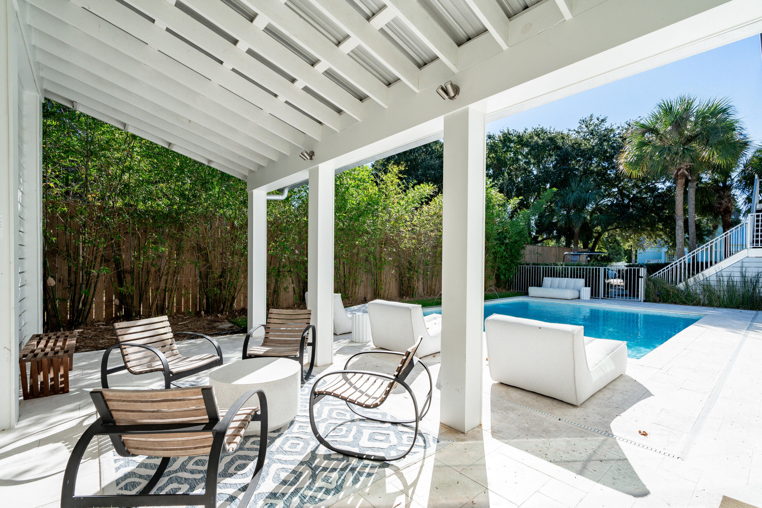 53 Buddy Street Santa Rosa Beach, FL 32459 - Photo 88 of 143 a view of a patio with couches chairs and a table and chairs with wooden floor and fence and garden view