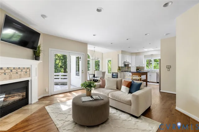 a living room with furniture a fireplace and a flat screen tv