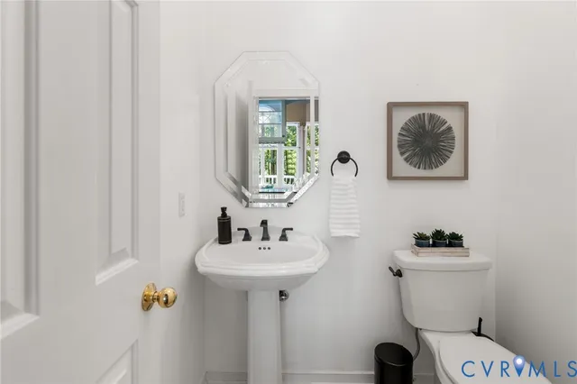 a bathroom with a sink a mirror and a toilet