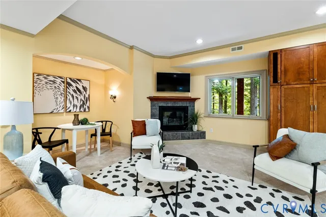 a living room with furniture and a potted plant