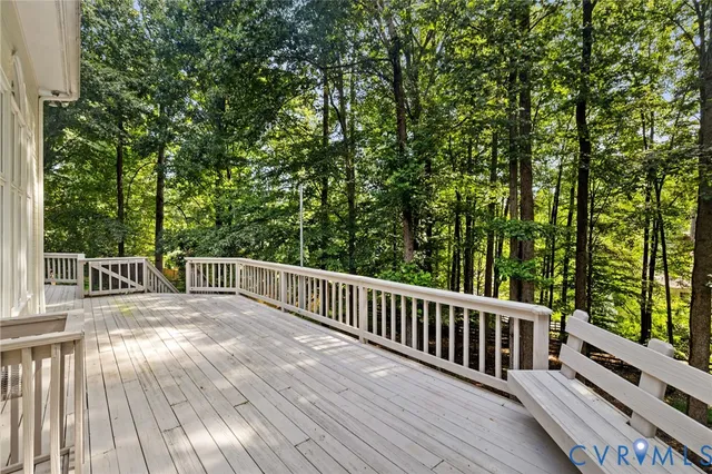 a view of balcony with wooden floor and fence