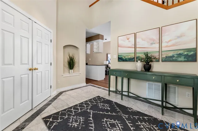 a living room with furniture a window and a potted plant