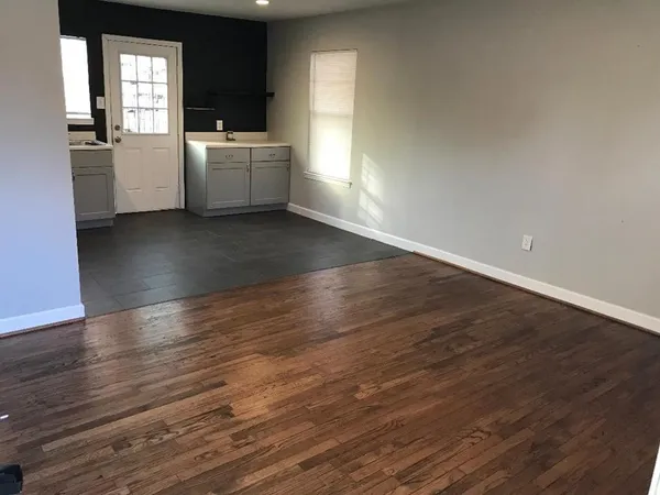 a view of a utility room with wooden floor and a sink