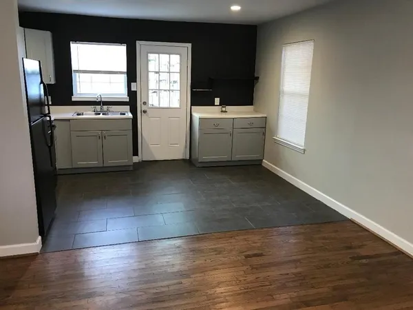 a kitchen with a sink a stove and cabinets