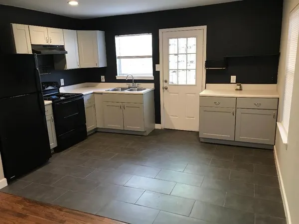 a kitchen with a sink stove and refrigerator