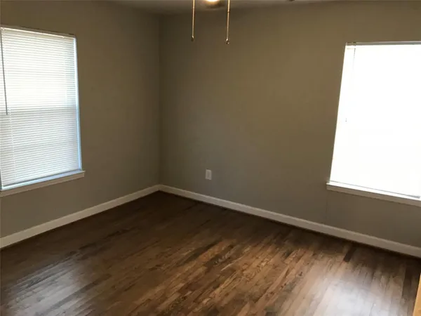 a view of a small space with wooden floor and a window