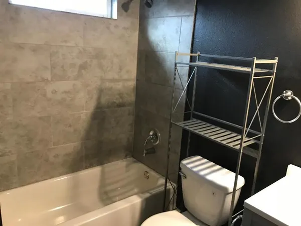 a bathroom with a toilet and a tub