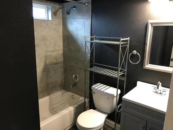 a bathroom with a toilet a sink and bathtub