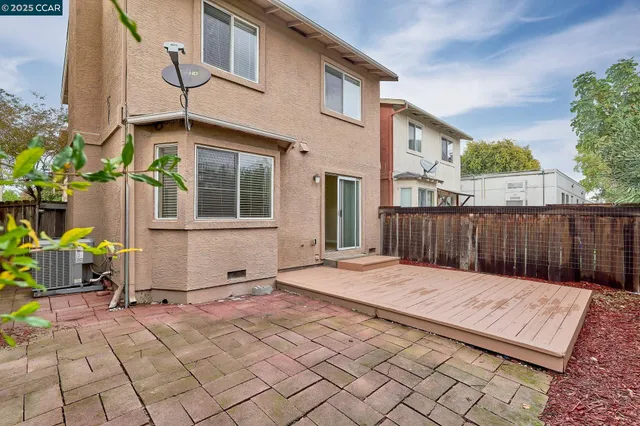 a backyard of a house with table and chairs