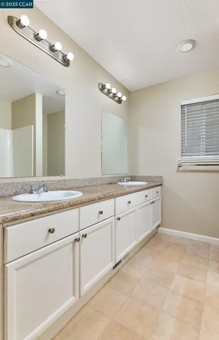 a spacious bathroom with a granite countertop sink a mirror and a