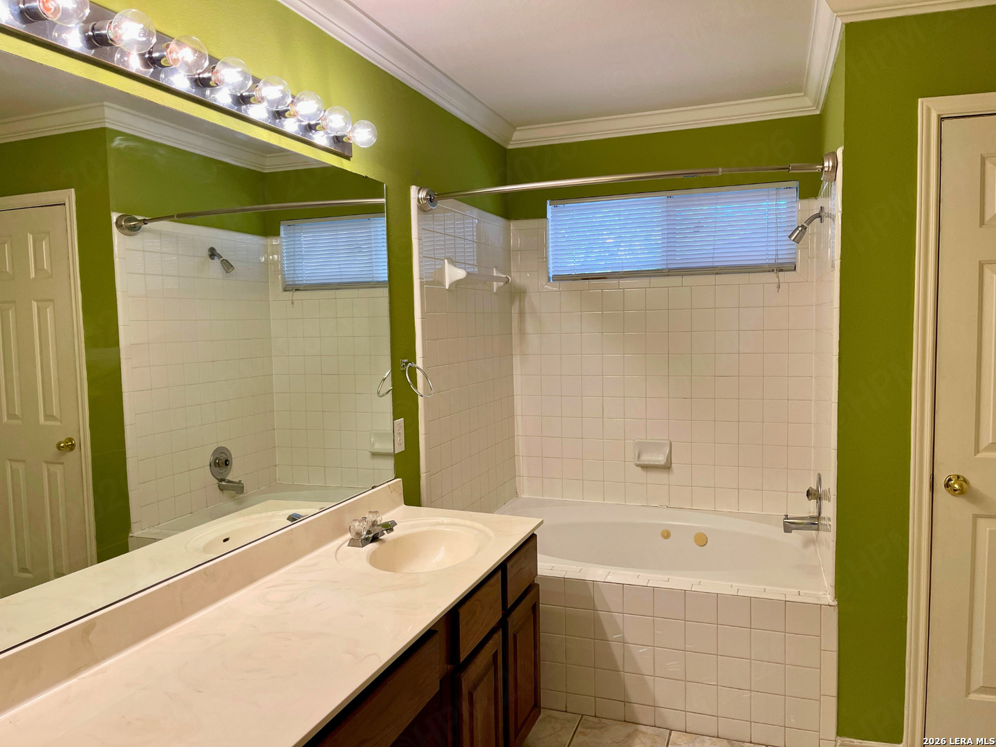 12219 Stable Rd Drive San Antonio, TX 78249 - Photo 15 of 21 a bathroom with a granite countertop sink a mirror and a bathtub