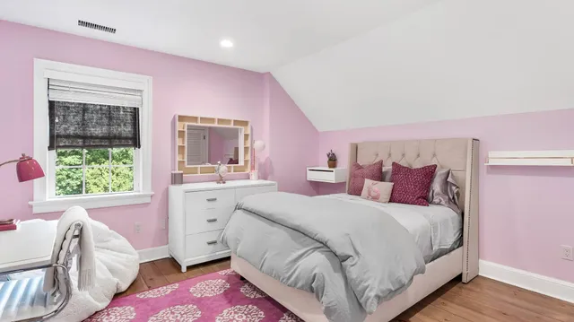 a bed room with a bed and a large window