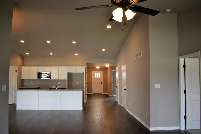a view of a hallway with wooden floor