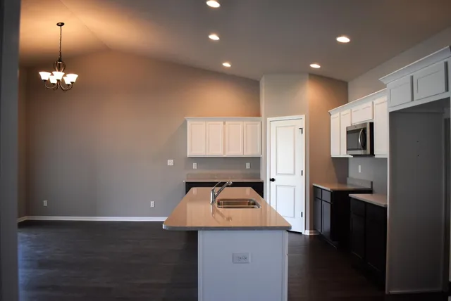 a kitchen with stainless steel appliances a refrigerator and a stove top oven