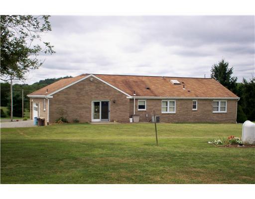 41 Kaufman Road Gibsonia, PA 15044 - Photo 10 of 11 Exterior Back. There is a man door as well as a 2 car garage and extra parking in wide driveway.
