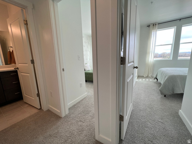 718 West Blue Magic Lane, Unit S201 Midvale, UT 84047 - Photo 7 of 18 Bedroom featuring light colored carpet and ensuite bath