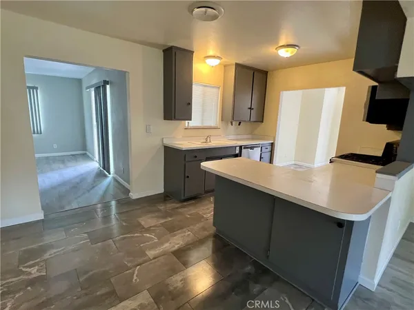 a kitchen with a sink refrigerator and microwave