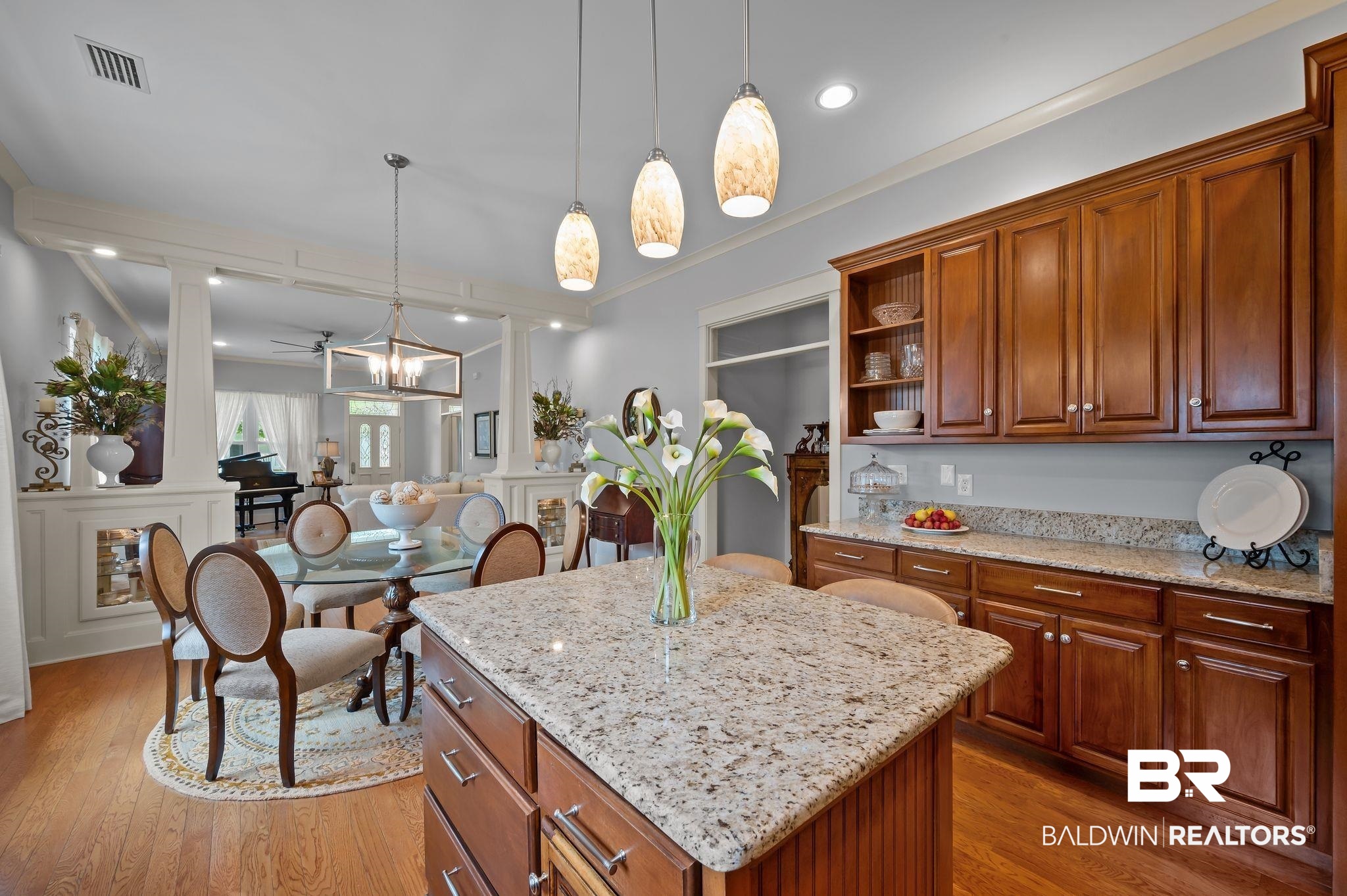 905 Buttercup Lane Foley, AL 36535 - Photo 24 of 47 Kitchen with open shelves, ornate columns, a center island, pendant lighting, and ornamental molding