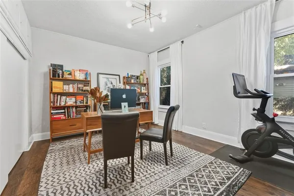 a view of a workspace with furniture and a window
