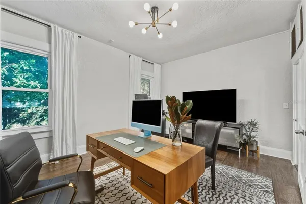 a bedroom with a bed and a painting on the wall