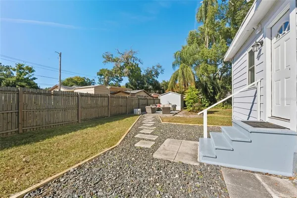 a front view of house with yard outdoor seating and barbeque oven