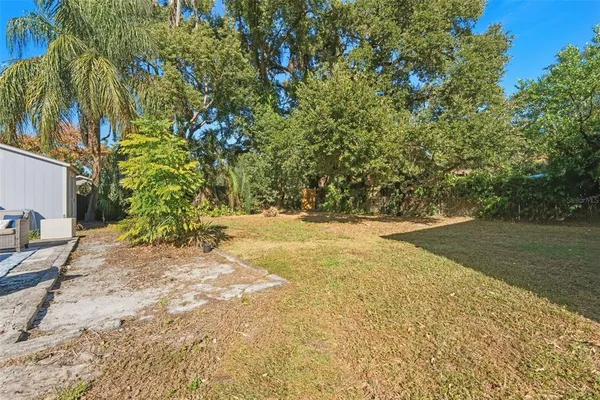 a view of a patio with a table and chairs and potted plants