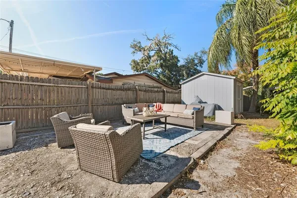 a view of a yard with wooden fence