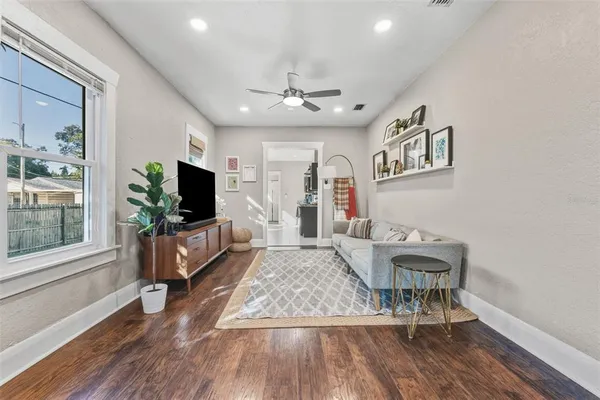 a living room with furniture and a flat screen tv