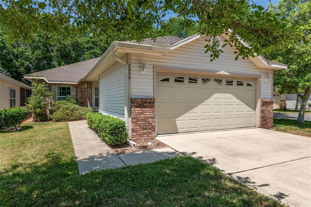 7976 48 Way Gainesville, FL 32653 - Photo 1 of 26 a front view of a house with a yard and garage
