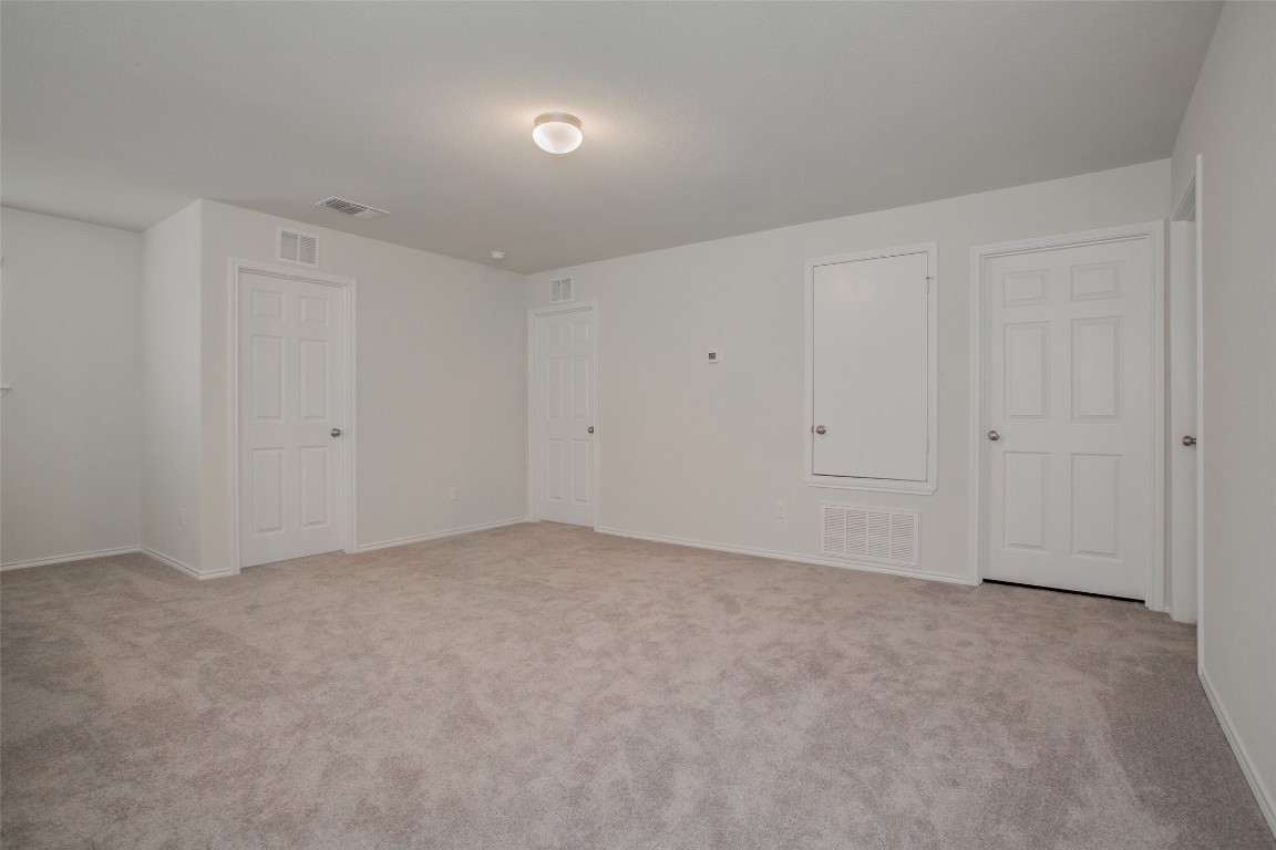 148 Spotted Rail Ridge Leander, TX 78641 - Photo 17 of 31 A spacious, neutral room offers a versatile canvas for living and personalization.