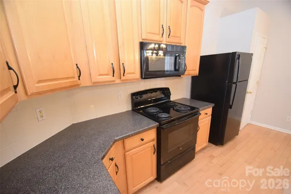 an empty room with a ceiling fan and carpet