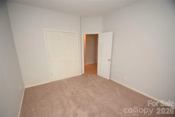 a room with a bed and wooden floor