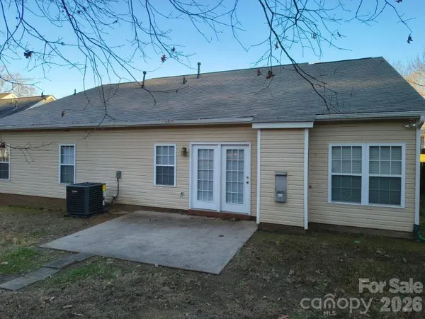 a backyard of a house with lots of trees