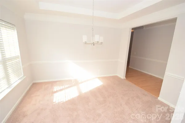 a view of an empty room with a fireplace and a window