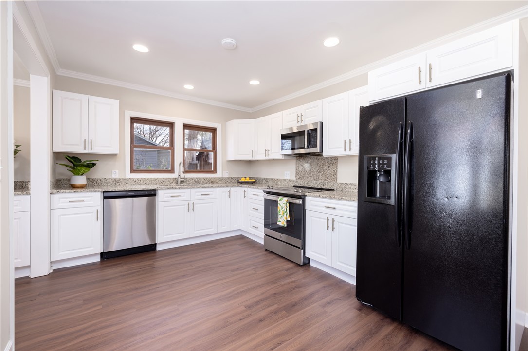 204 Old Salem Road Seneca, SC 29672 - Photo 9 of 28 This modern kitchen features crisp cabinetry, stone countertops, and integrated appliances.