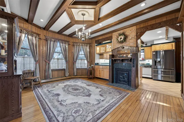 a view of a hallway with a couch and wooden floor