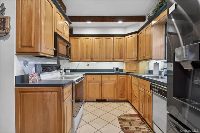 a kitchen with stainless steel appliances granite countertop a sink a stove and cabinets