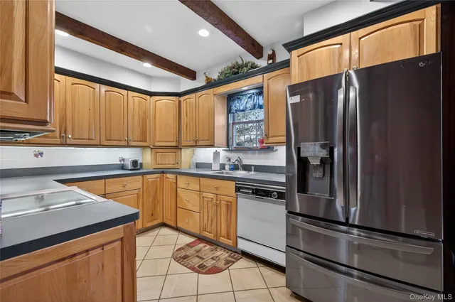 a kitchen with a refrigerator a sink and cabinets
