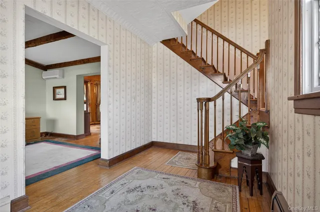 a view of an entryway with wooden floor