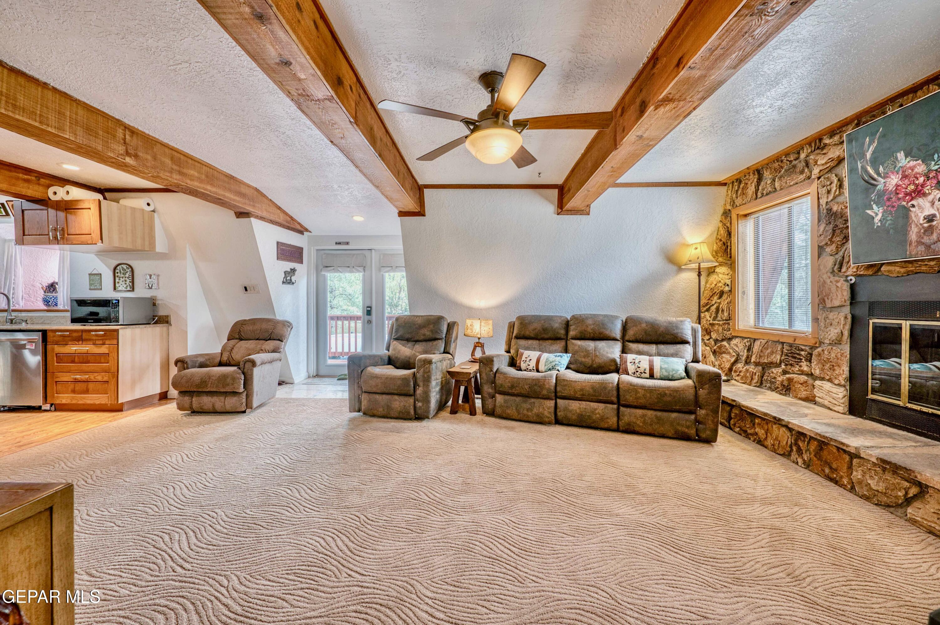 104 Meadow Wood Ruidoso, NM 88345 - Photo 13 of 55 a living room with furniture and a fireplace