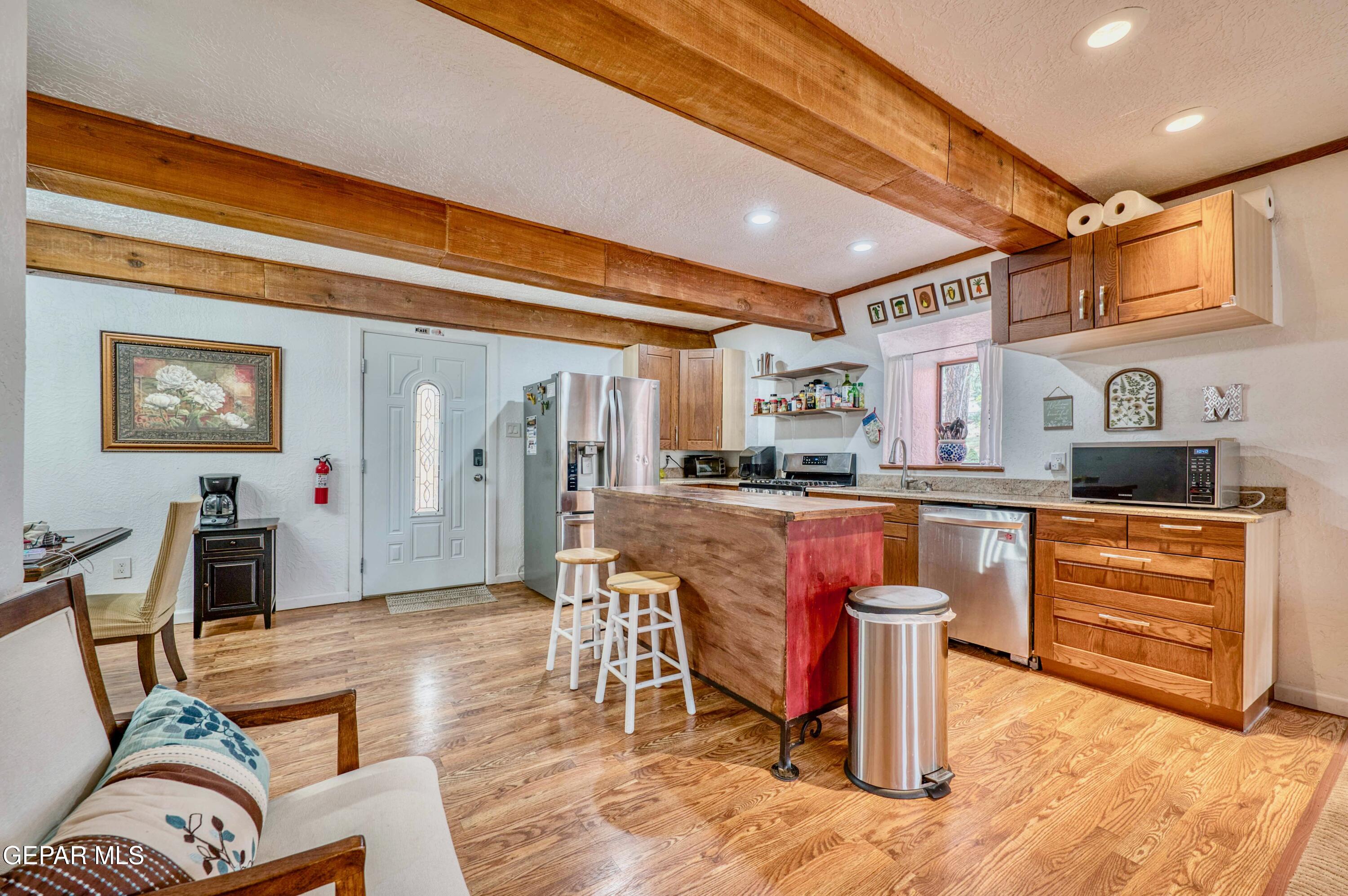 104 Meadow Wood Ruidoso, NM 88345 - Photo 16 of 55 a kitchen with stainless steel appliances granite countertop a refrigerator and stove top oven