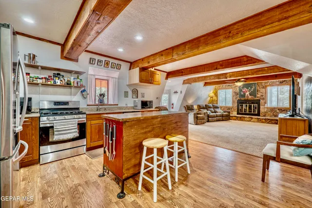 a kitchen with stainless steel appliances a stove and a sink