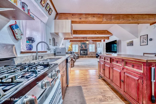 a kitchen with stainless steel appliances granite countertop a sink and cabinets