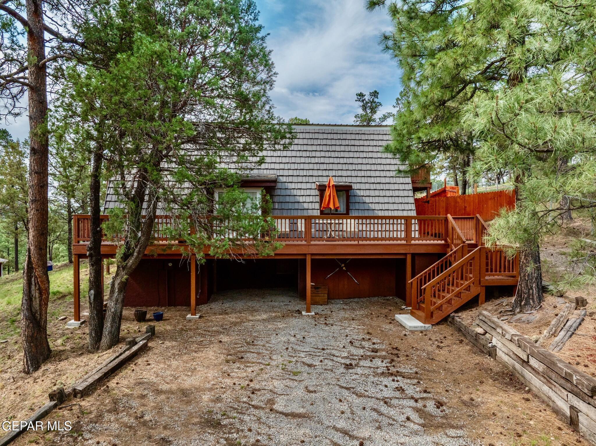 104 Meadow Wood Ruidoso, NM 88345 - Photo 2 of 55 a view of a backyard with a sitting area