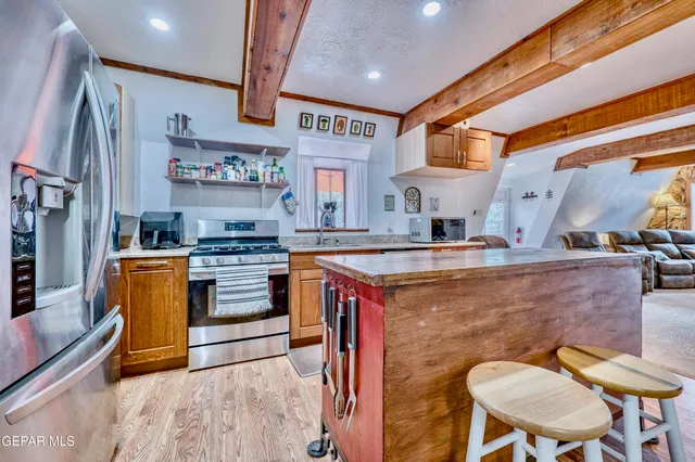 a kitchen with stainless steel appliances granite countertop a sink and wooden cabinets