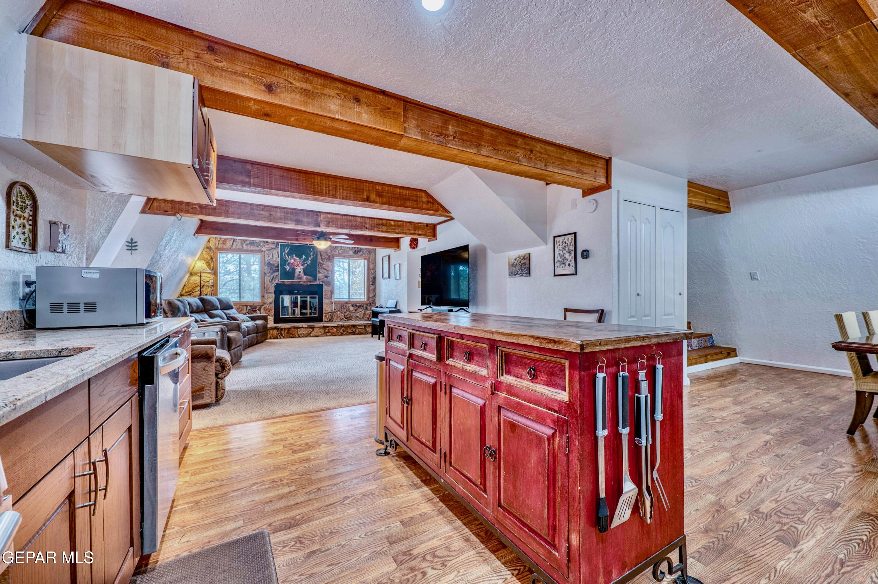 104 Meadow Wood Ruidoso, NM 88345 - Photo 24 of 55 a kitchen with stainless steel appliances granite countertop a sink and wooden cabinets