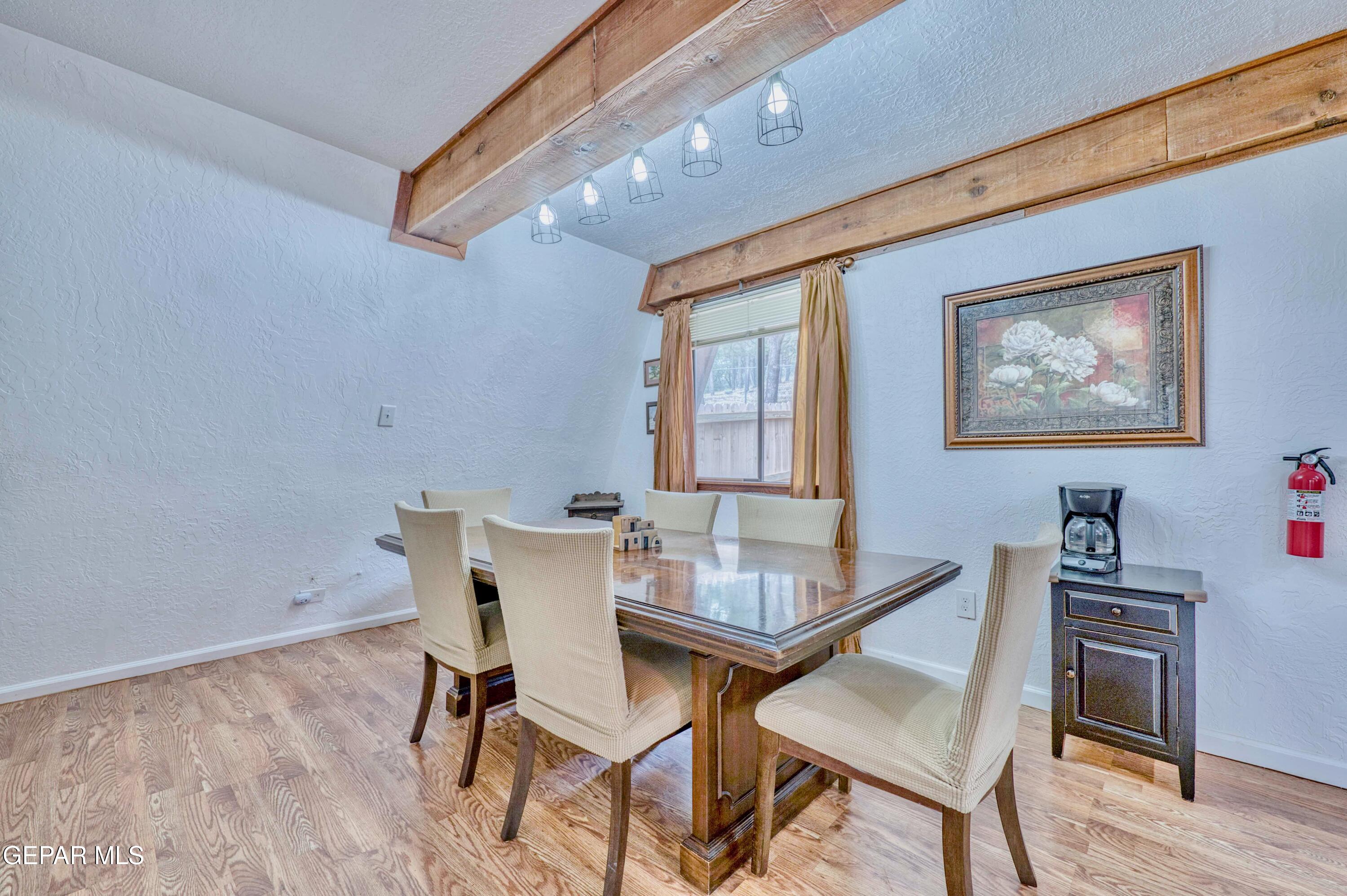 104 Meadow Wood Ruidoso, NM 88345 - Photo 27 of 55 a dining room with furniture and wooden floor