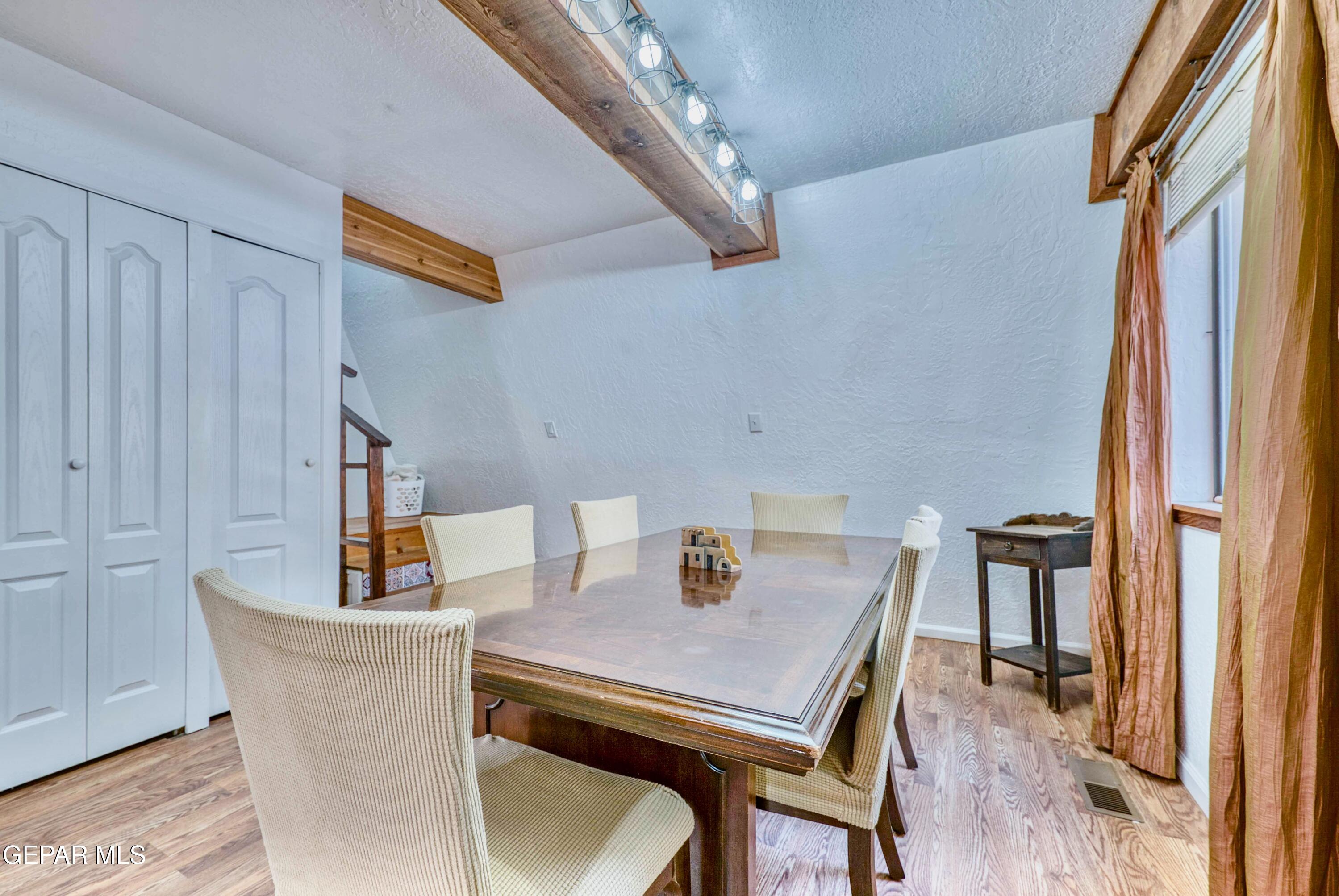 104 Meadow Wood Ruidoso, NM 88345 - Photo 29 of 55 a view of a dining room with furniture and wooden floor