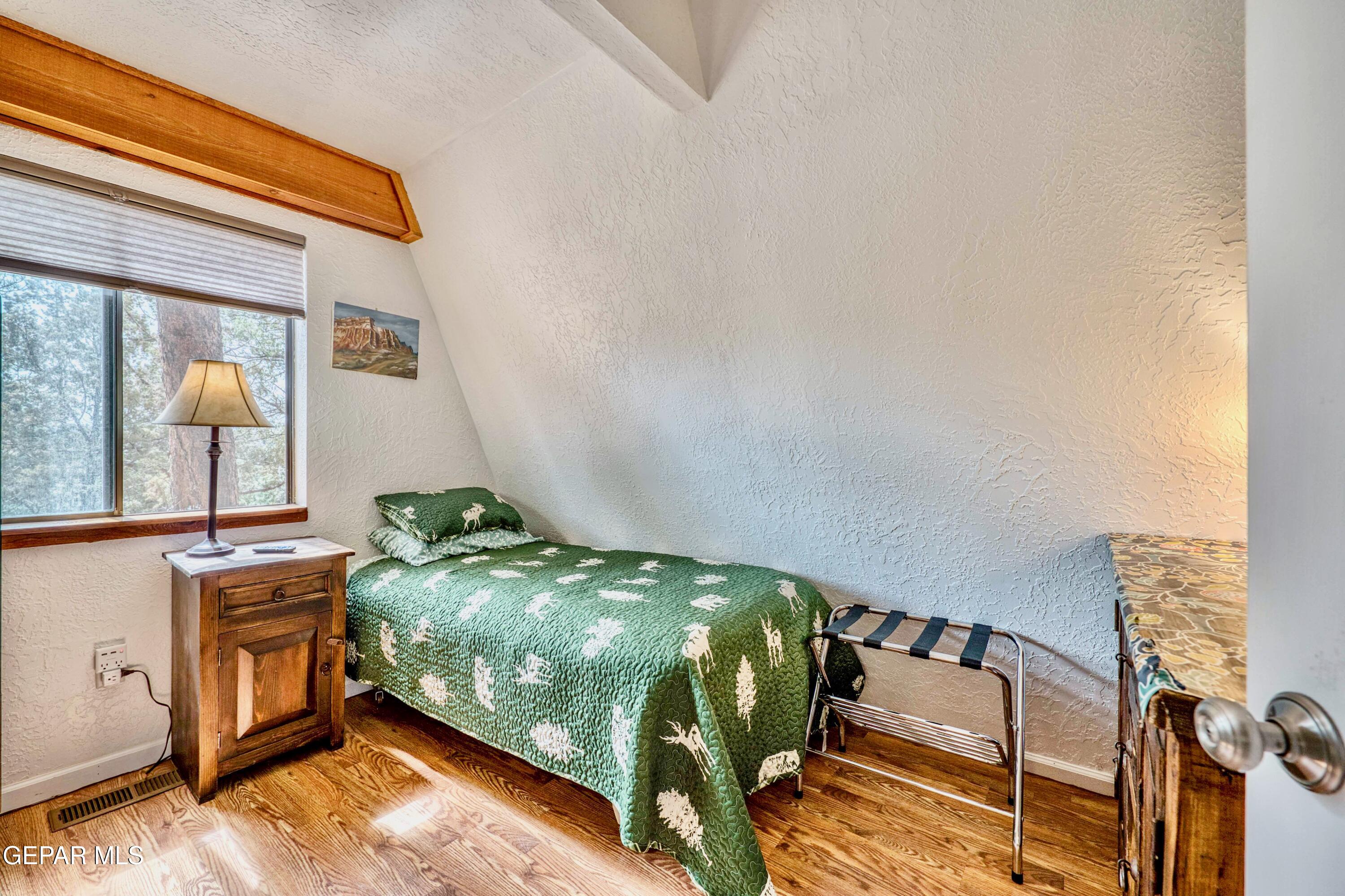 104 Meadow Wood Ruidoso, NM 88345 - Photo 30 of 55 a bedroom with bed and a window